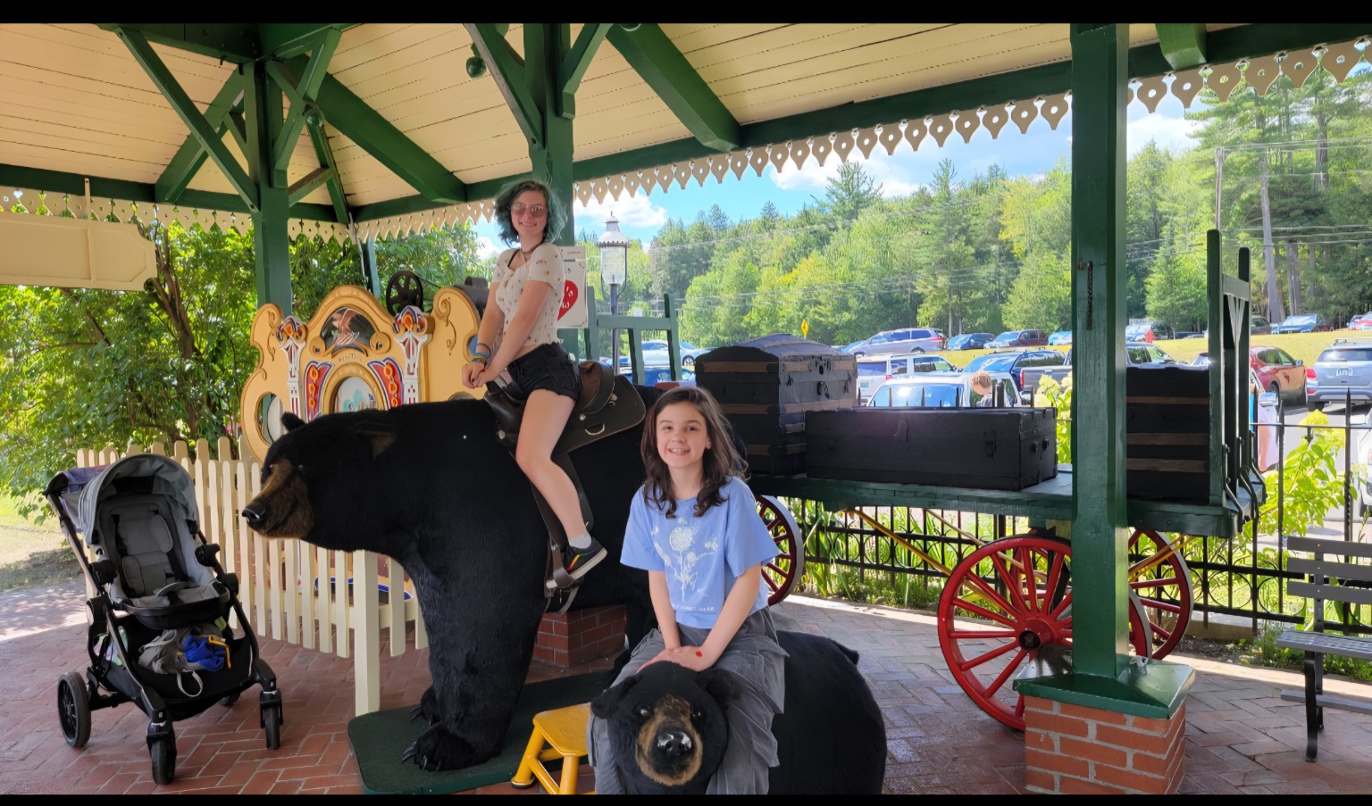 Girls posing beside bear photo props at Clark's Bears