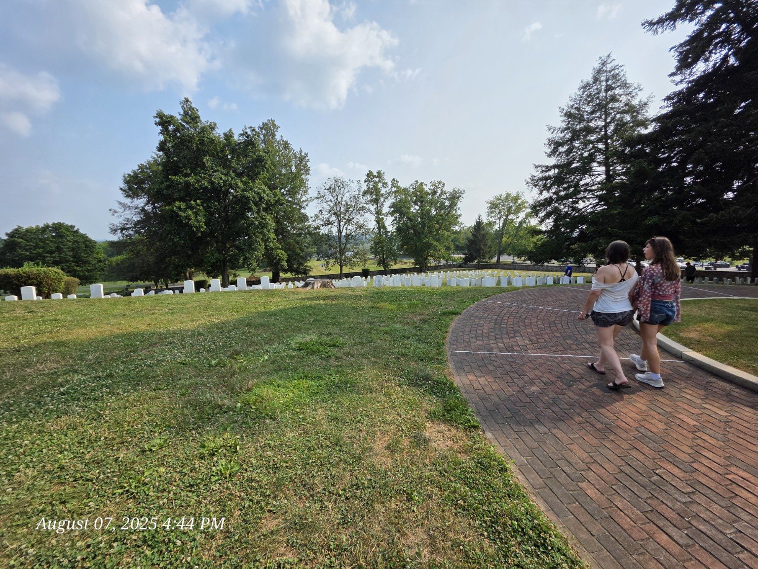 Family walking the curved brick path through Gettysburg National Cemetery