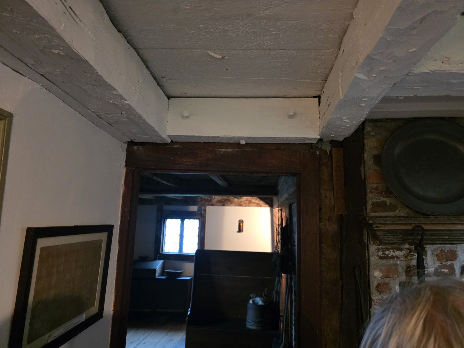 Low exposed beams and timber doorway inside the house