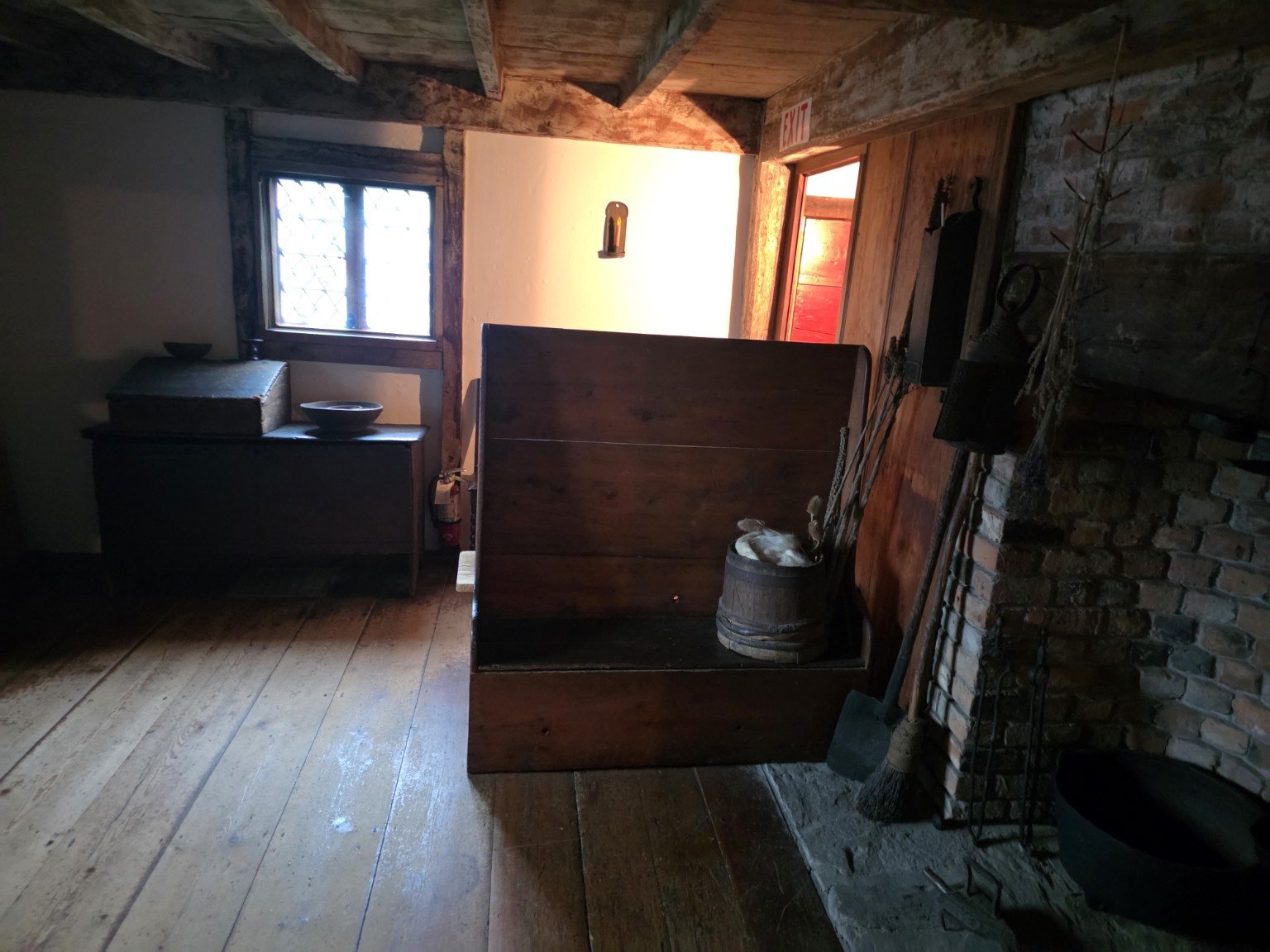 Main room with hearth and high-backed wooden settle