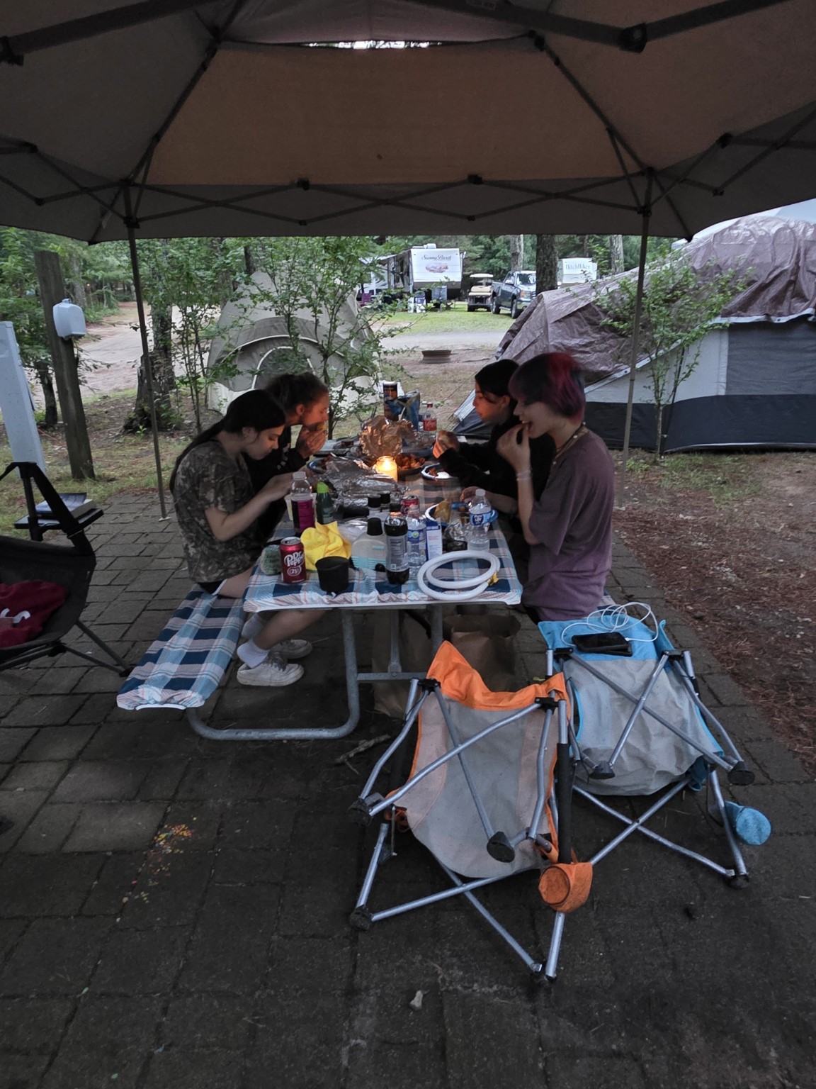 Trail Tater crew eating dinner beneath canopy