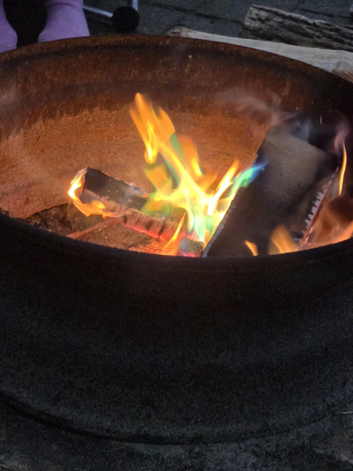 Green and blue flames in campfire