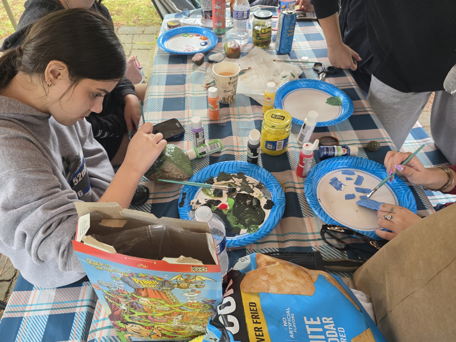 Painting colorful campground rocks