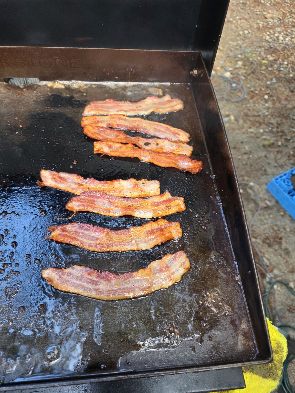 Bacon cooking on the Blackstone
