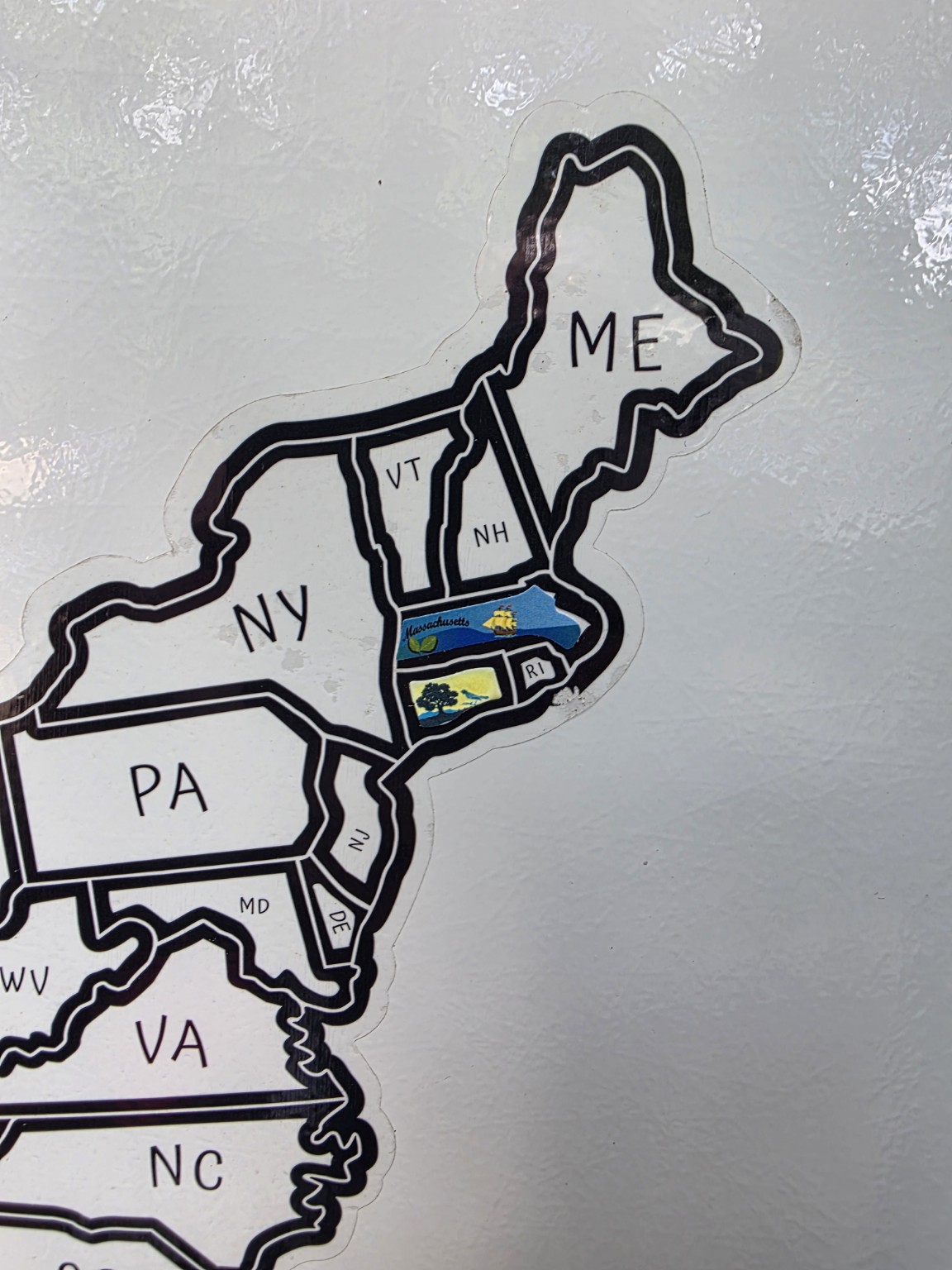 Close-up of Connecticut and Massachusetts stickers, including the Mayflower on the Massachusetts sticker