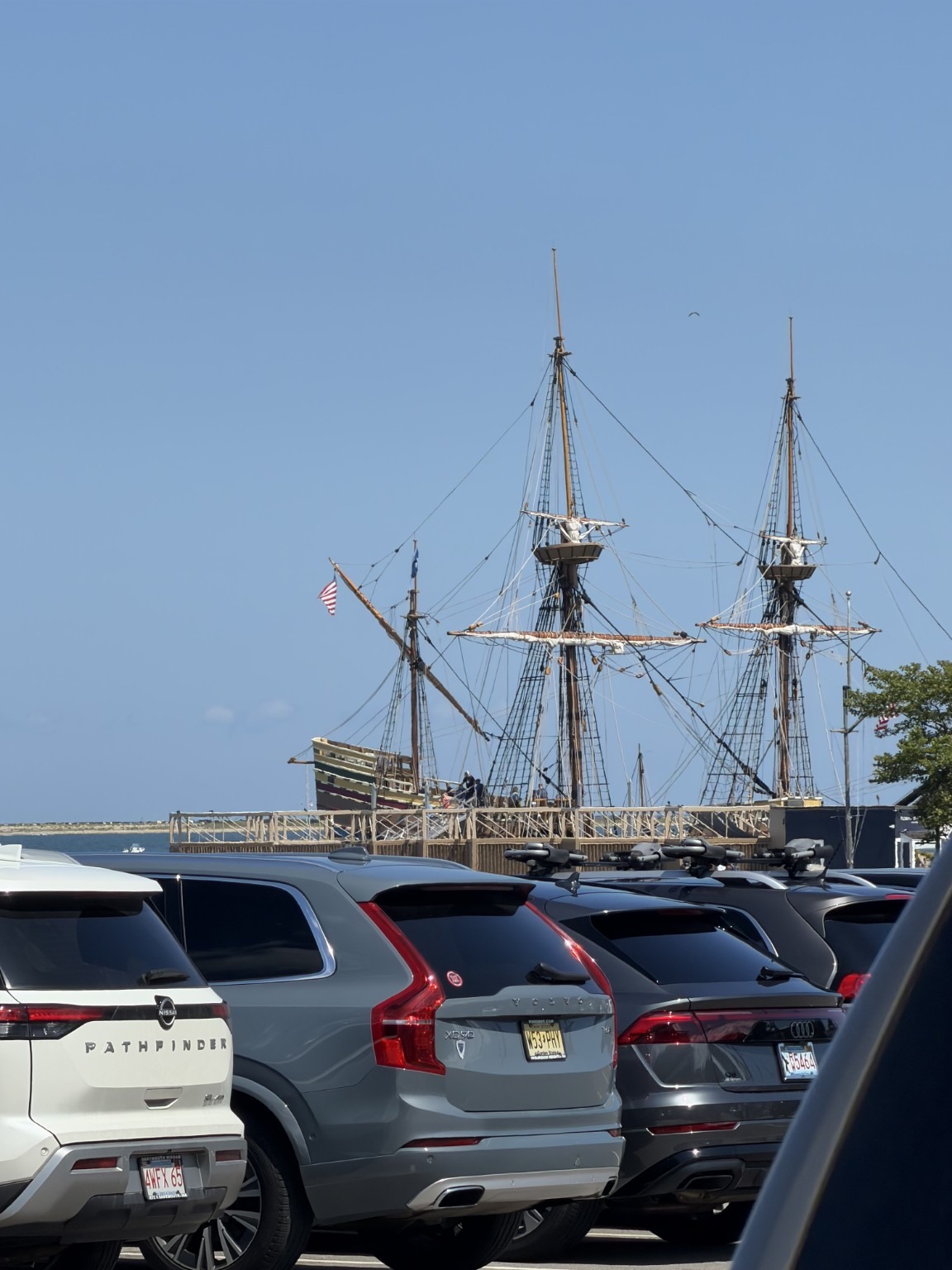 Mayflower II visible above the parked cars on Plymouth's waterfront