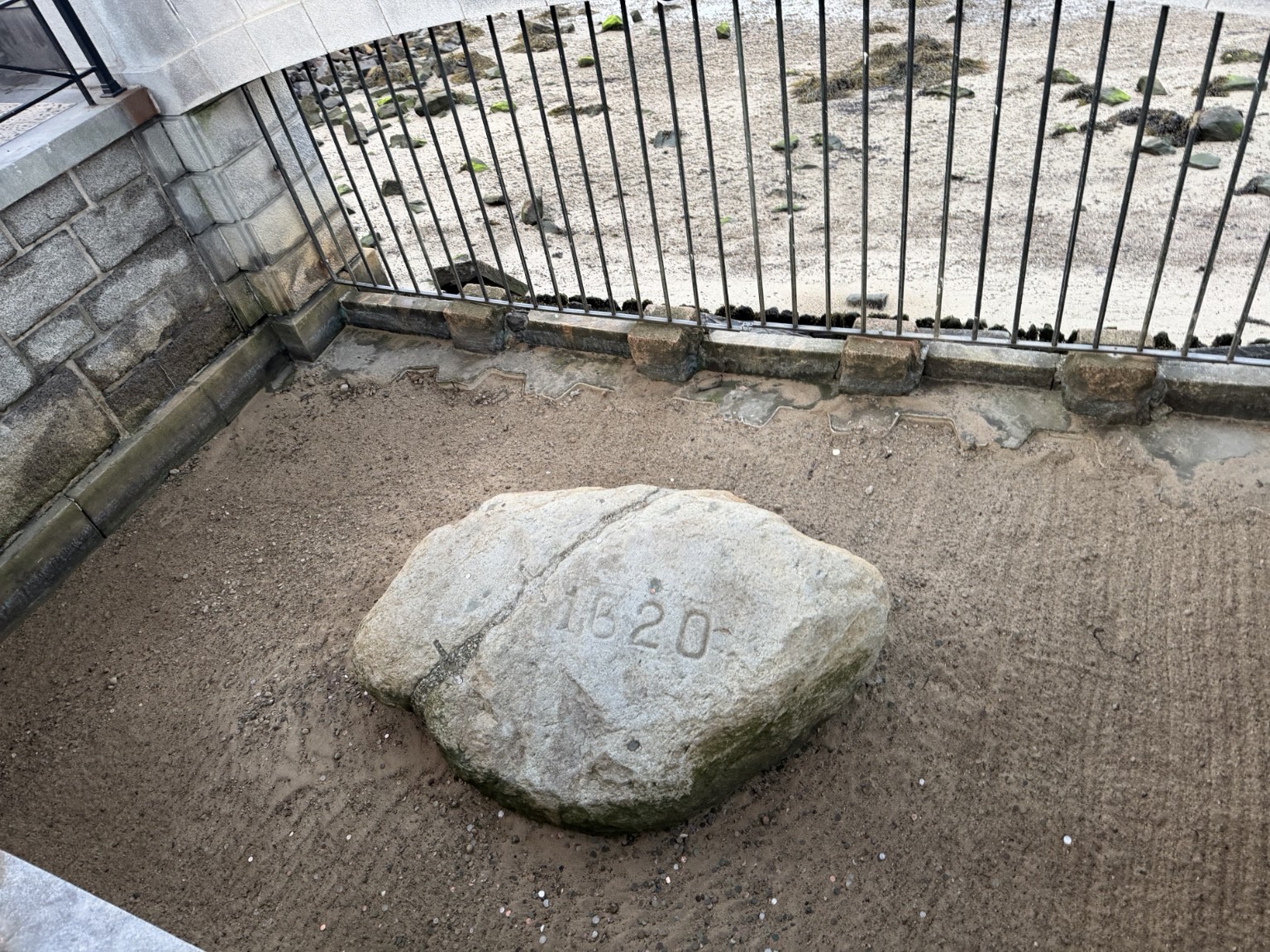 Plymouth Rock marked 1620 beneath the waterfront portico