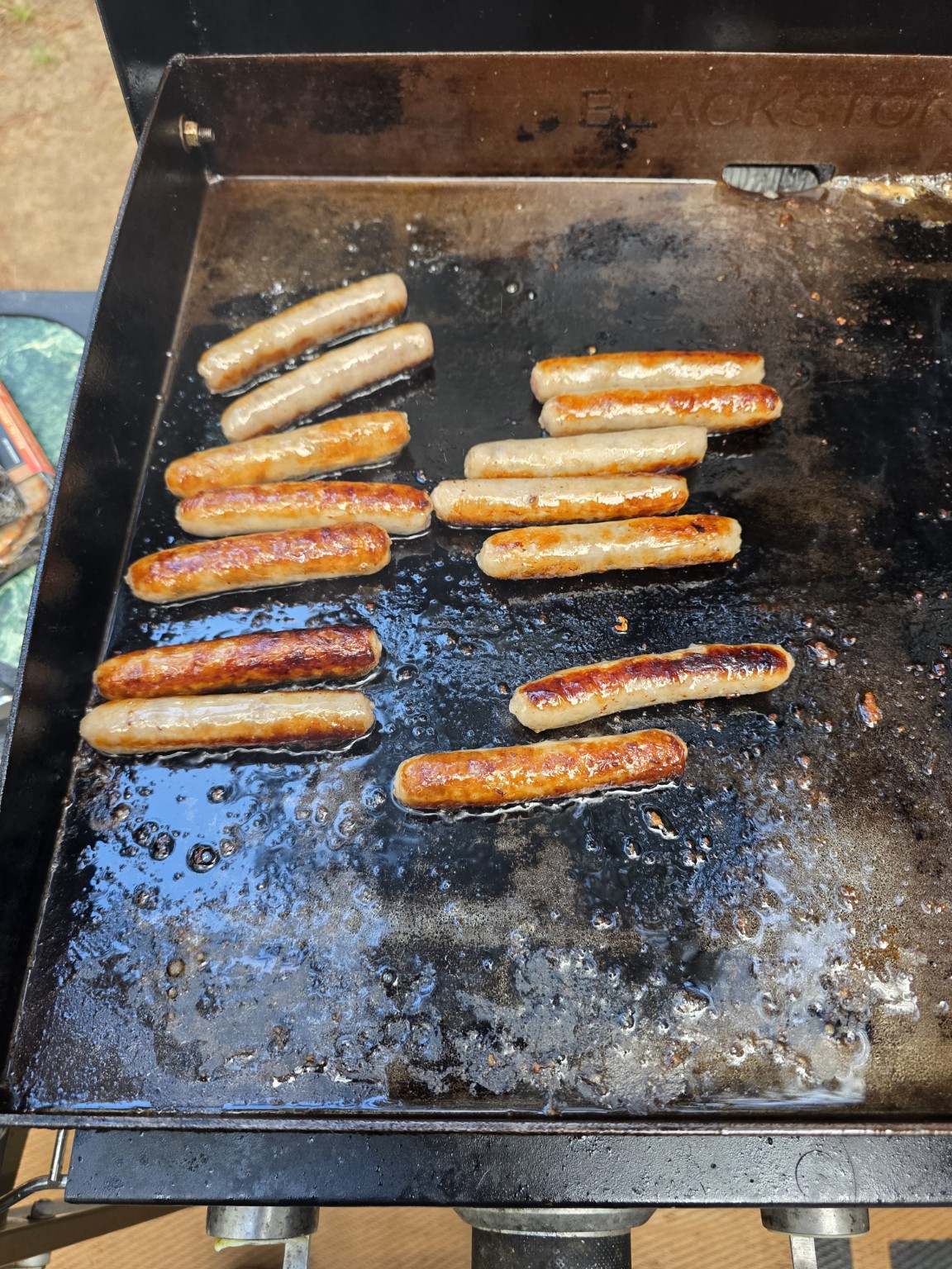 Breakfast sausage links browning on the Blackstone