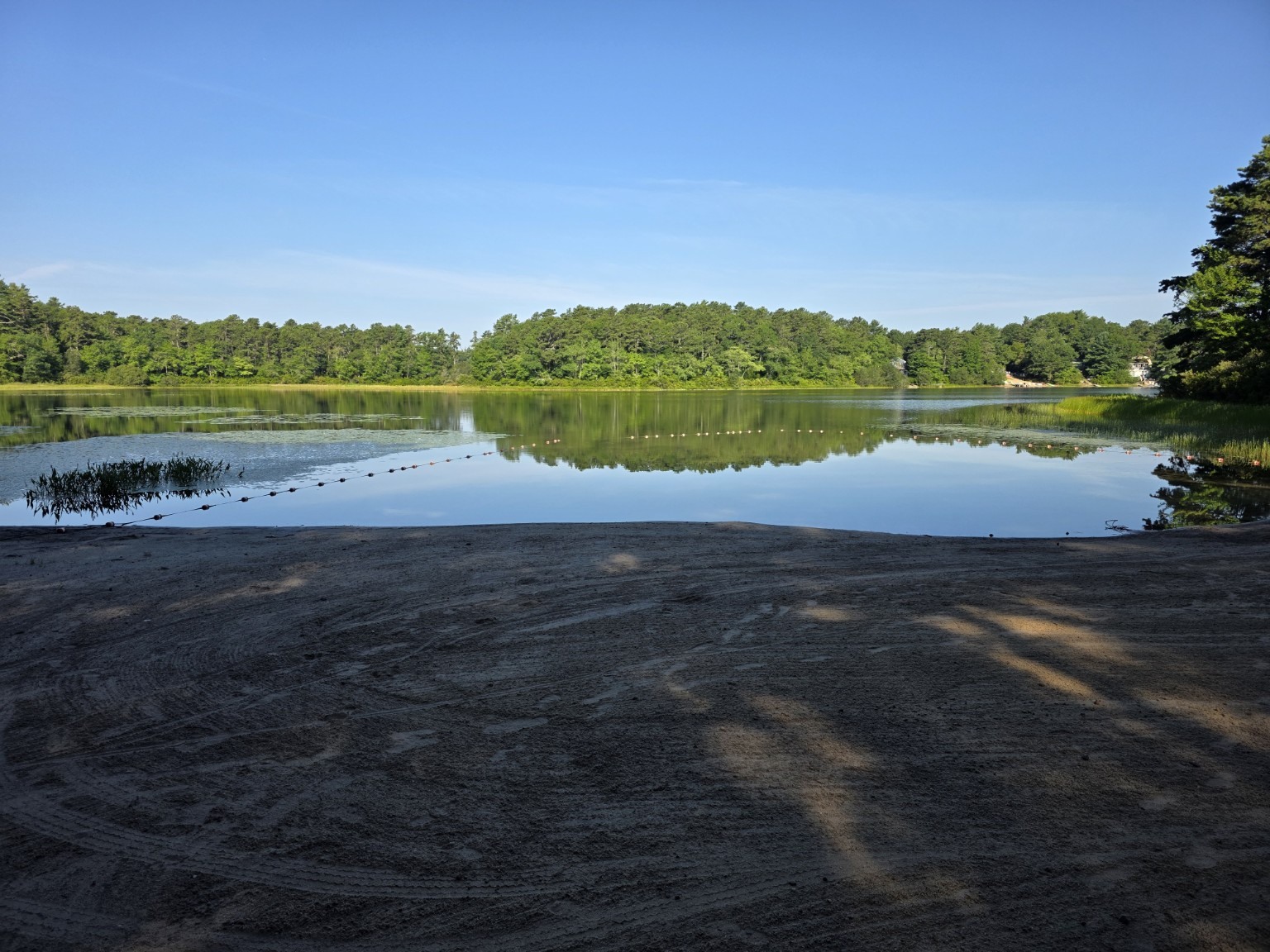 Quiet swimming beach and calm water at Sandy Pond Campground